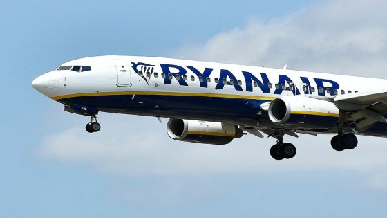 (FILES) In this file photo taken on July 1, 2022 a Ryanair Boeing 737-8AS aircraft lands at El Prat airport in Barcelona. Hungary slapped a fine on Irish airline Ryanair on August 8, 2022 for passing on to customers the cost of a special tax that Budapest has imposed on some companies in response to surging inflation. (Photo by Pau BARRENA / AFP)